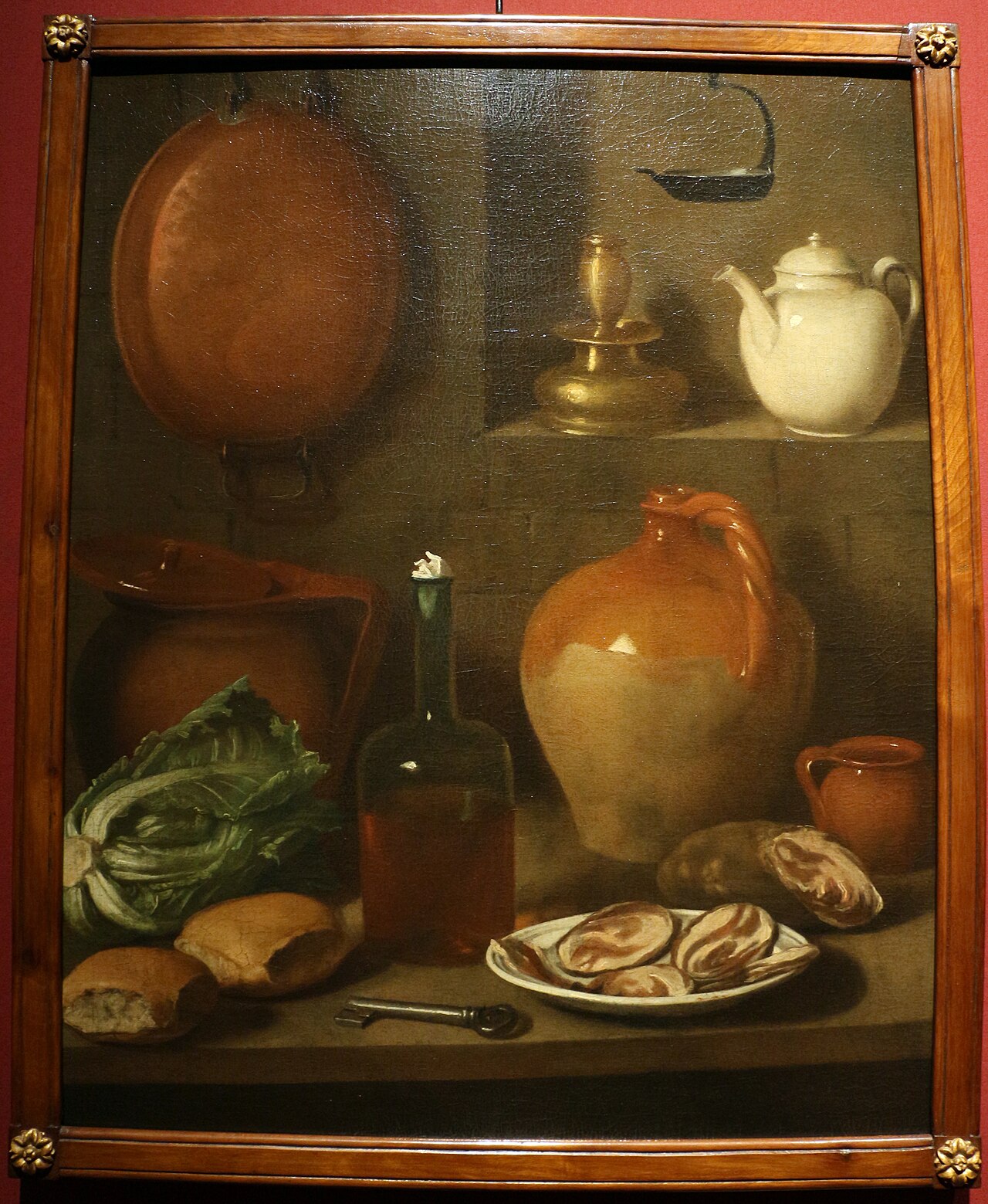 Bread, a bottle of wine, vegetables, and an oil lamp hanging on the wall: a still life by Carlo Magini, from the second half of the eighteenth century.